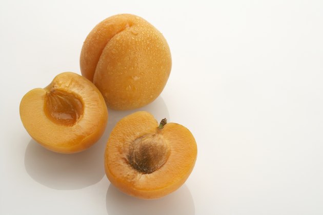 Two apricots, one split in half