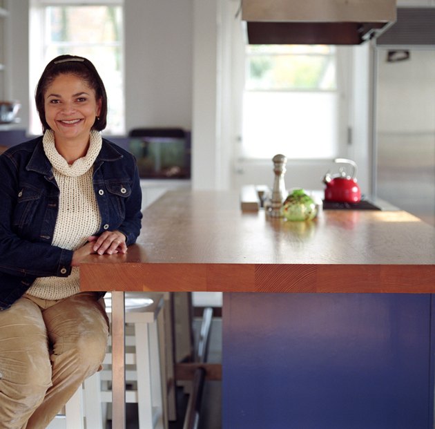 Woman Sitting at Kitchen Bar