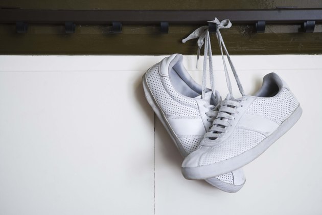Tennis shoes hanging from locker room peg
