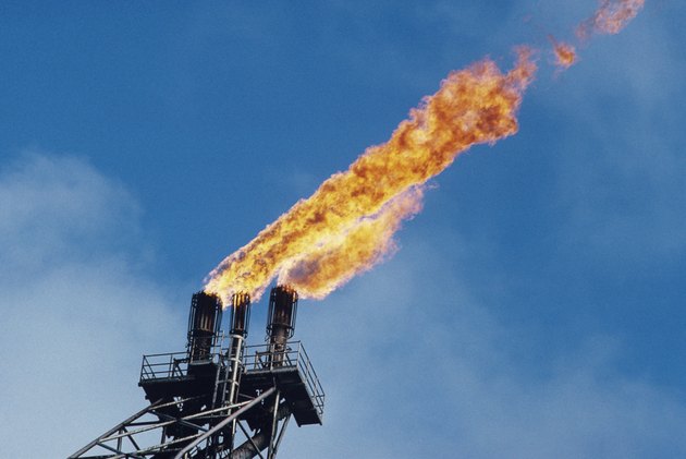 Offshore oil platform; "burn off" oil fume flames, low angle view