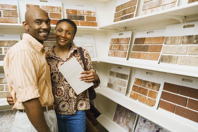 Smiling couple by tile samples