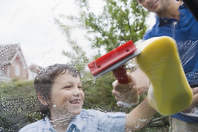 Father and son washing car