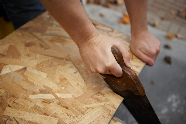 Hands with handsaw