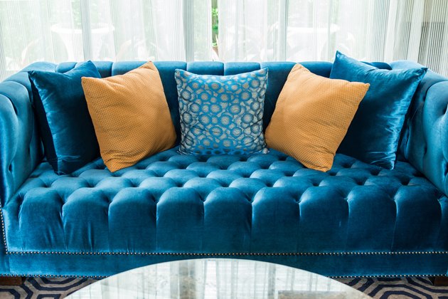 row of pillows on sofa in living room