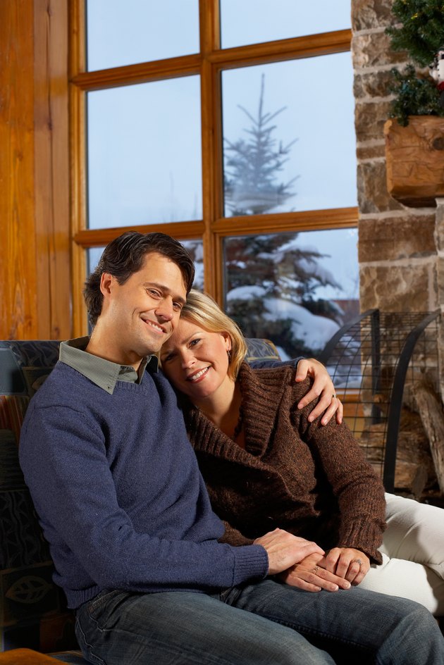 Couple snuggling in rustic chalet