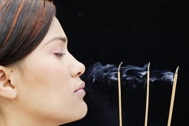Woman meditating with incense
