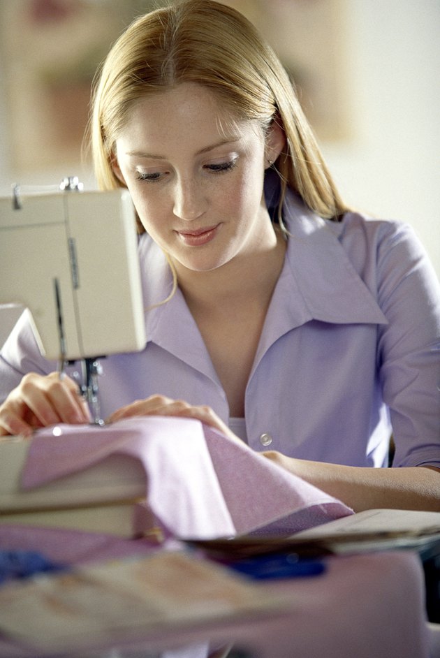 Teenage girl using sewing machine