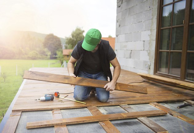 Handyman installing wooden flooring