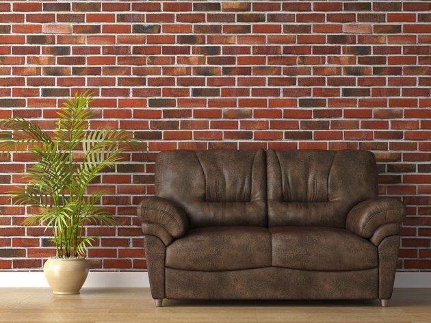 leather couch on brick wall