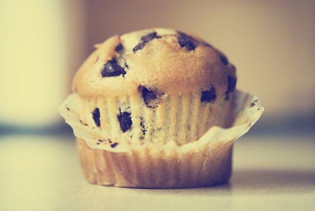 Half unwrapped chocolate chip muffin