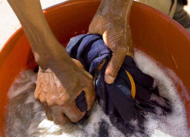 african hands washing laundry