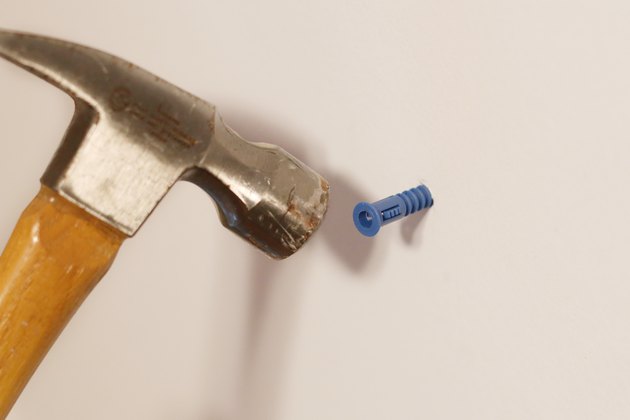 how-to-hang-something-heavy-into-drywall-without-studs-hunker