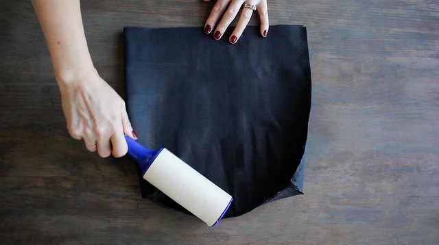 Lint rolling over fabric to remove dust or lint