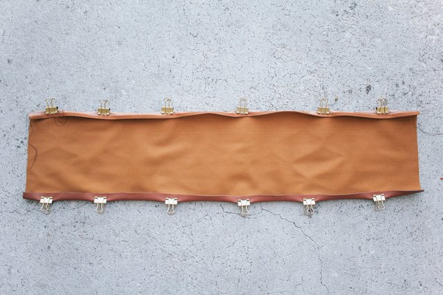 Top and bottom seams of chair back folded and clipped in place