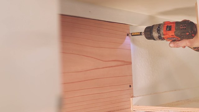 Drilling redwood board to back of cabinet