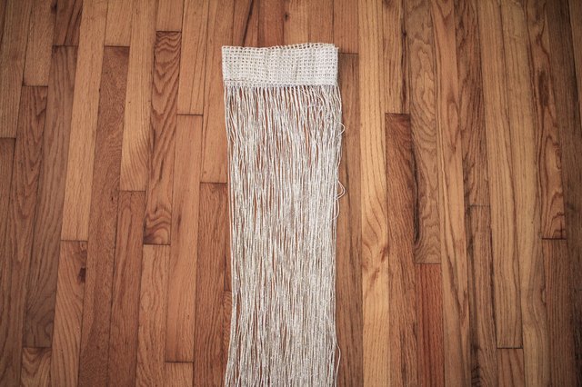 Fringe curtain panel folded in fourths
