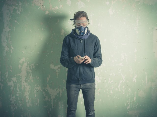 Young woman in protective gear using smart phone