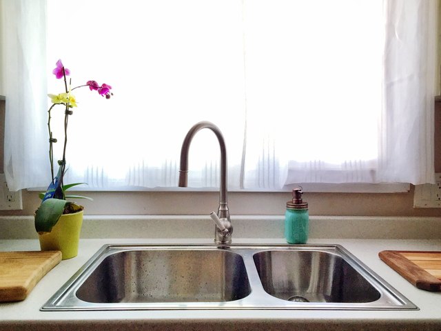 Faucet And Sink Against Window At Home