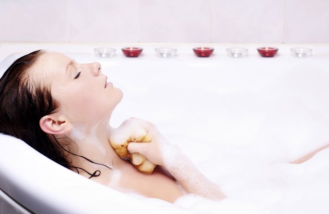 Young woman enjoys the bath-foam