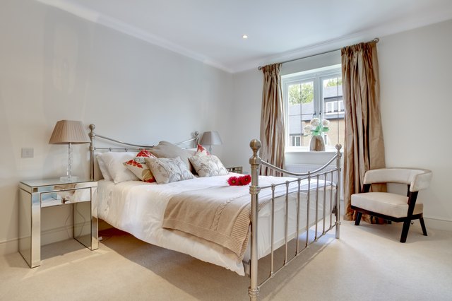 Metal bedsteads add a decorative touch to the bedroom.