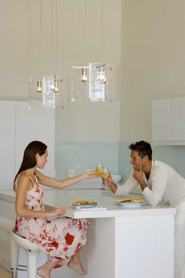 Man and woman toasting over salad