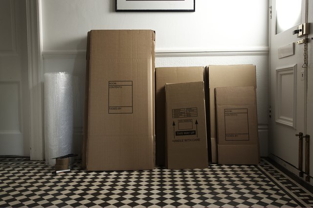 collapsed packing boxes stacked in hall