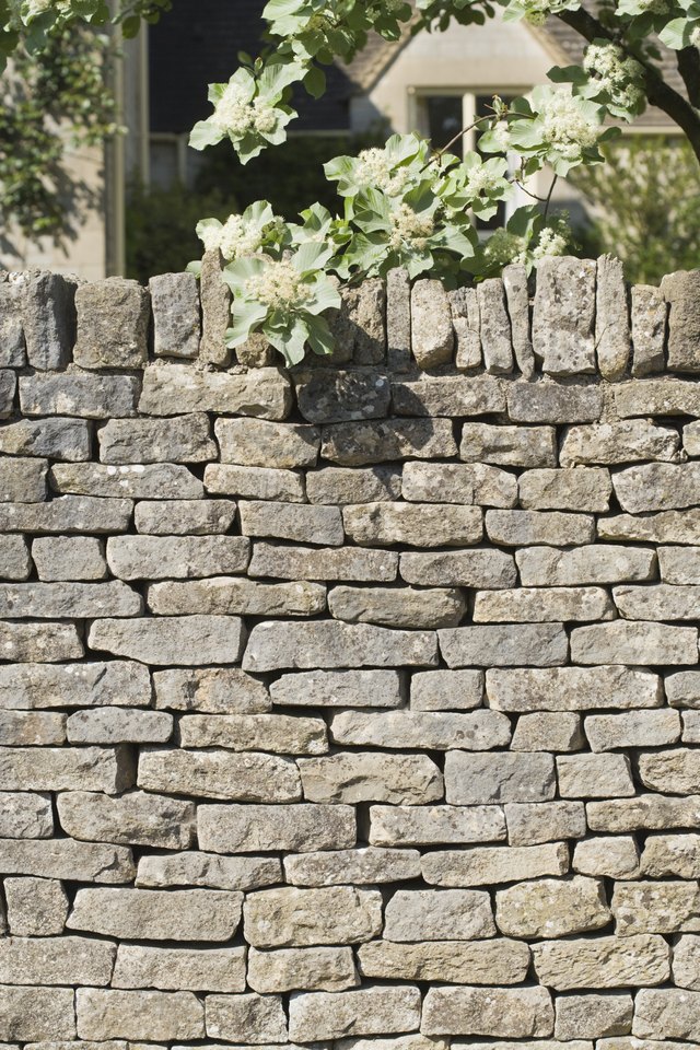 Stone wall covering house