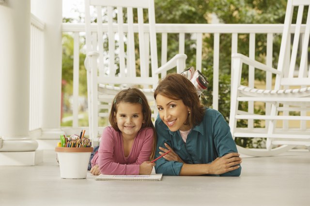 Hispanic mother and daughter coloring