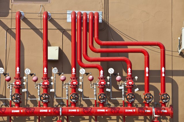 splinker alarm system, red water pipe, brown wall, outdoor