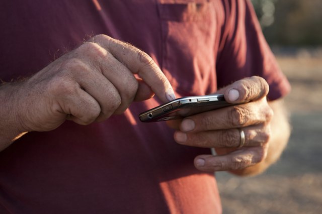 Farmer's hands using a smartphone