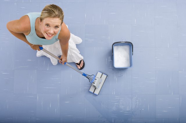 Woman mopping with mop and bucket