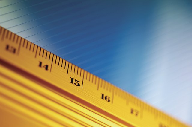 Close-up of yellow ruler against blue and white background
