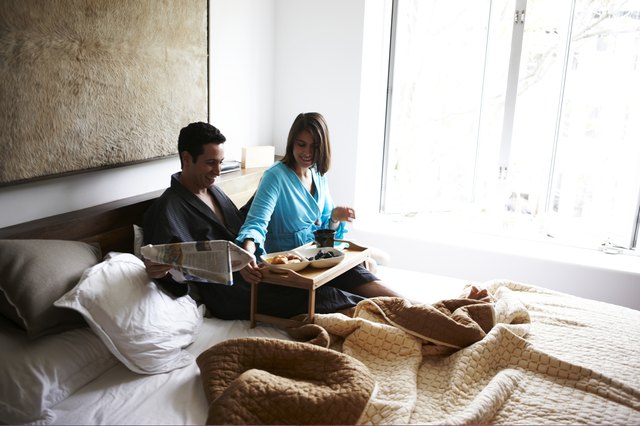 Hispanic couple in luxury bedroom