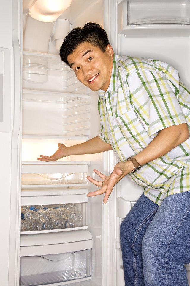 Man gesturing in front of refrigerator