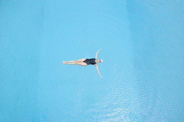 Woman floating in swimming pool