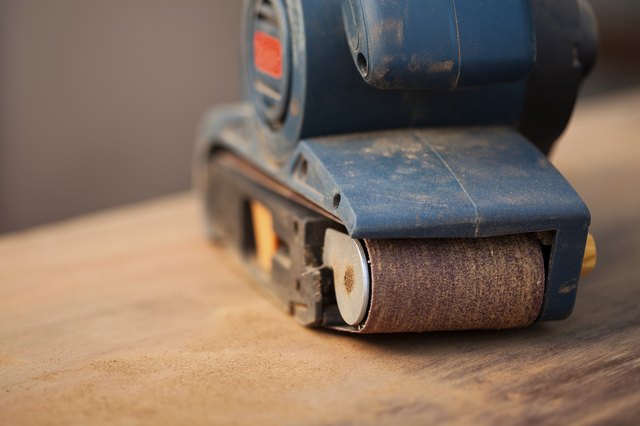 Belt sander on a wooden surface