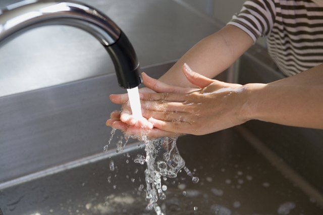 Boy Washing Hands by Water