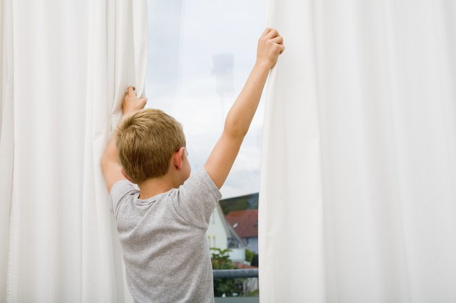 Boy looking out window