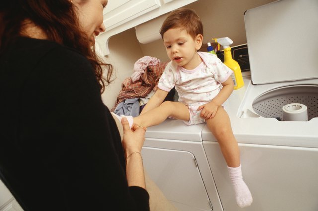 Mother and child (21-24 months) in laundry room