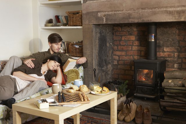 Young couple relaxing by fire