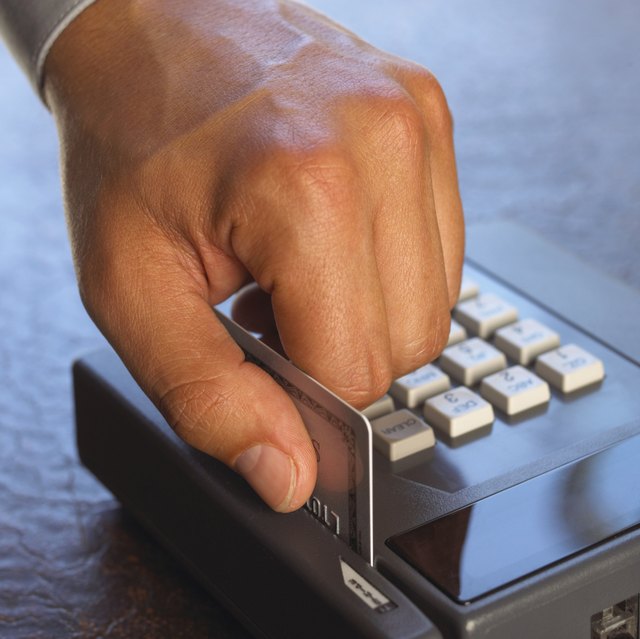 Man sliding credit card through machine