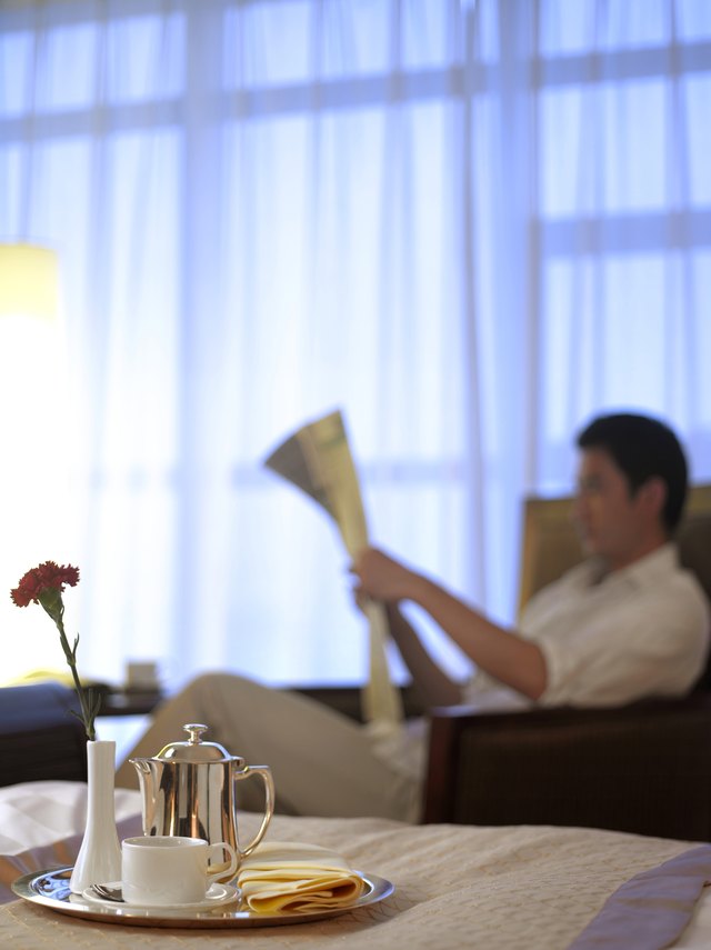 Room service tray, man reading newspaper