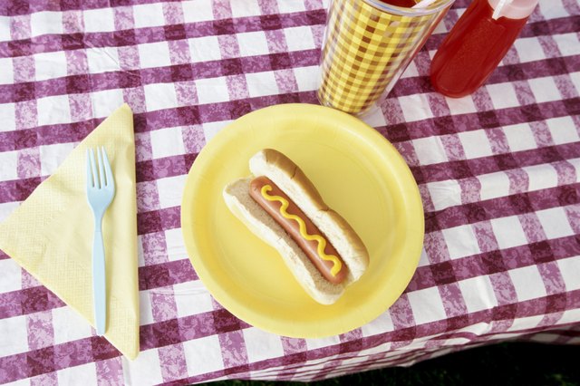 Hot dog on plate on picnic table