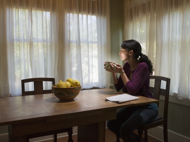 Woman holding coffee cup with light coming out