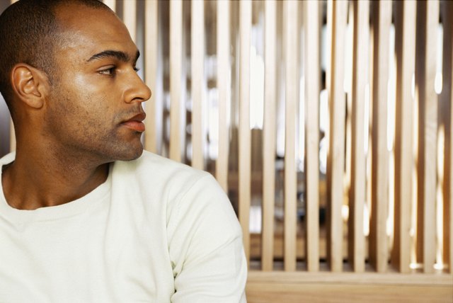 close-up of a young man looking through a window