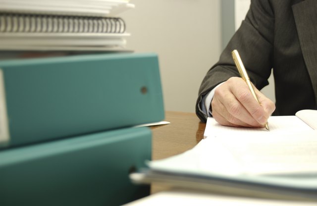 Busy businessman writing paperwork
