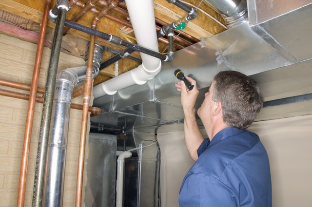Handyman inspecting pipes