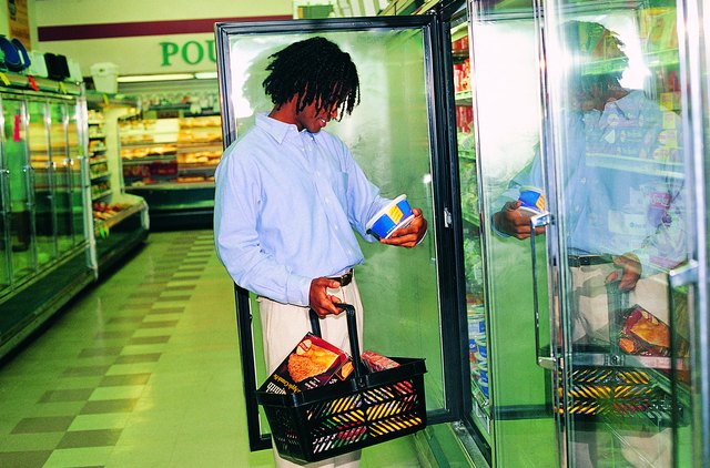 Man looking at frozen foods in grocery store
