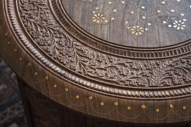 Top of carved wooden coffee table with flower pattern