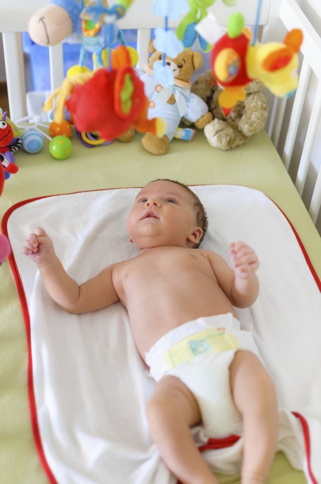 Cute baby playing in bed